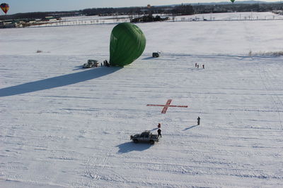 People skiing on snow covered land