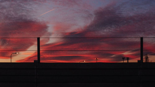 Low angle view of silhouette building against sky during sunset