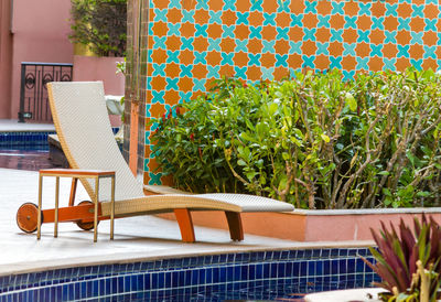 Empty chairs and tables in swimming pool