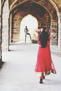 Full length of woman standing on railing