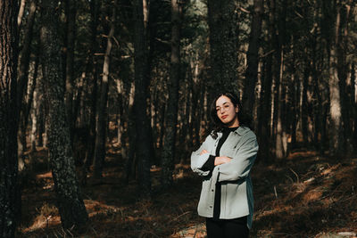 Young woman standing in forest