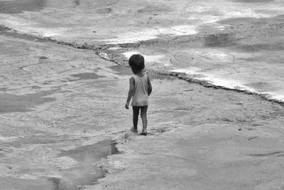 Rear view of boy on field