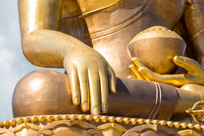 Low angle view of golden buddha statue