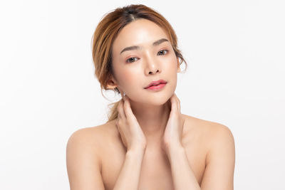 Portrait of a beautiful young woman over white background