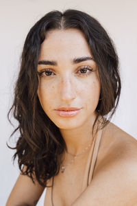 Young beautiful woman against white background