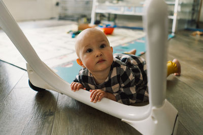 Cute baby girl playing with a toy on a play mat.