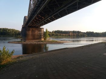 Arch bridge over river against sky