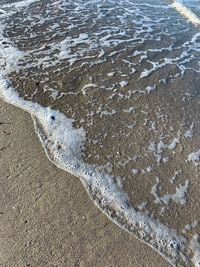 High angle view of wet sand on beach