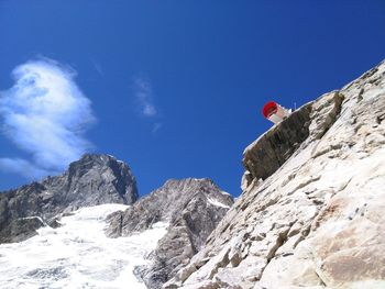 Low angle view of snowcapped mountains against sky