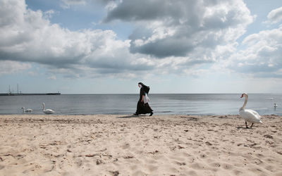 Man standing on beach against sky