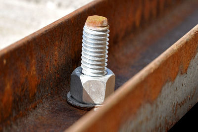 Close-up of nut on rusty metal