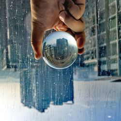 Midsection of person holding glass