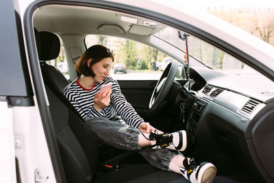 Portrait of woman sitting in car