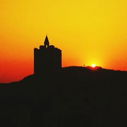 Silhouette of built structure at sunset