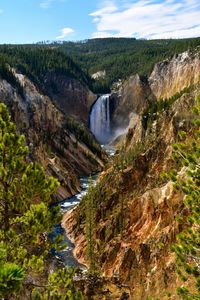 Scenic view of waterfall against sky