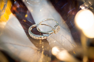 Close-up of wedding rings on glass