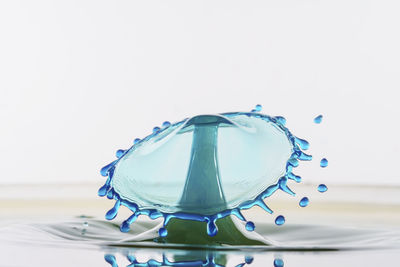 Close-up of wine glass on table against white background