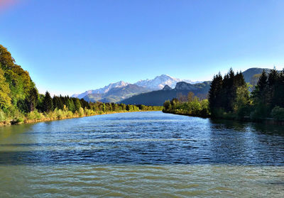 Scenic view of lake against clear blue sky