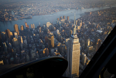 An aerial helicopter view of the empire state building in new york.