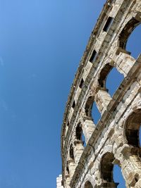 Low angle view of historical building against blue sky