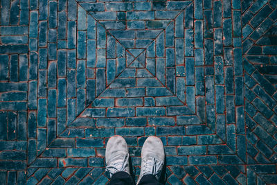 Low section of person standing on footpath