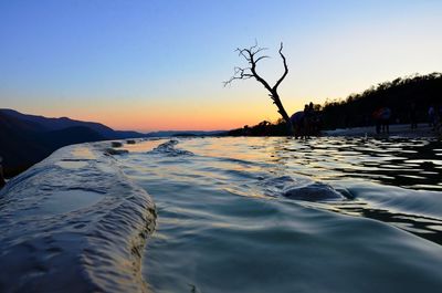 Scenic view of sea against clear sky during sunset