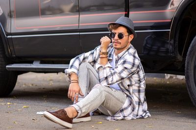 Young man sitting in car