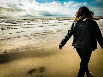 Rear view of woman looking at sea shore