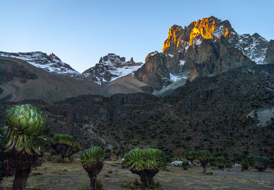 Scenic view of snowcapped mountains against clear sky