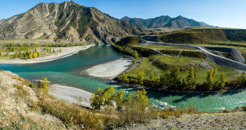 Scenic view of lake and mountains against sky