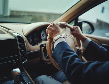 Cropped image of man driving car