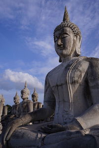 Statue of temple against building