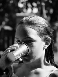 Close-up of young woman drinking water