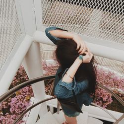 High angle view of woman standing on staircase