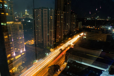 High angle view of illuminated city buildings at night