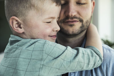 Close-up portrait of father and son