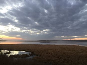 Scenic view of beach against dramatic sky