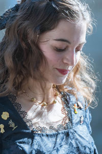 Close-up of smiling young woman looking down