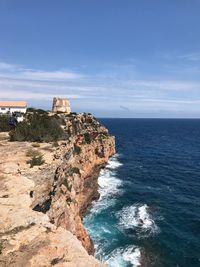 Rock formations by sea against sky