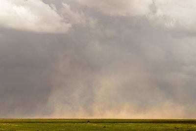 Scenic view of landscape against cloudy sky