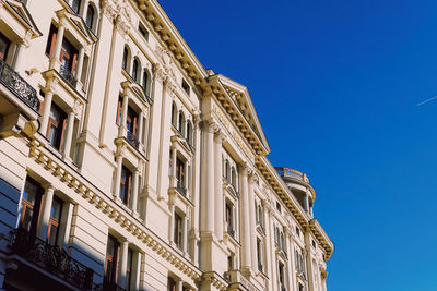 Low angle view of building against clear blue sky