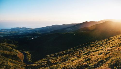 Scenic view of mountains against clear sky during sunset