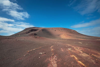 Scenic view of arid landscape against sky