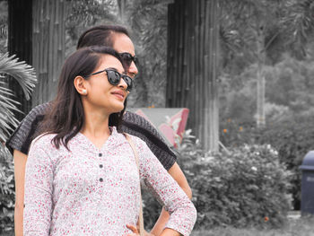 Young woman wearing sunglasses standing outdoors