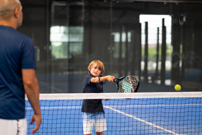 Portrait of boy playing tennis