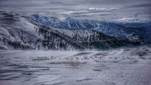 Scenic view of mountains against sky during winter