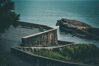 Built structure by sea against sky