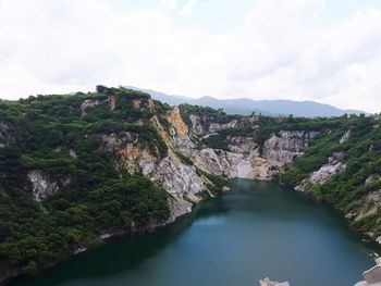 Scenic view of river amidst mountains against sky