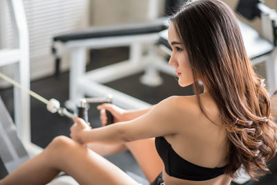 High angle view of young woman exercising in gym