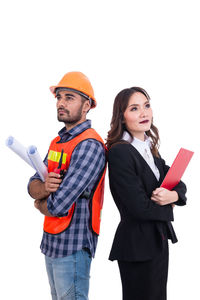 Young couple standing against white background